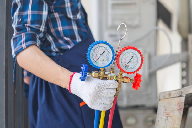 istock Air Conditioning Repair, Repairman fixing air conditioning system 1495022798
