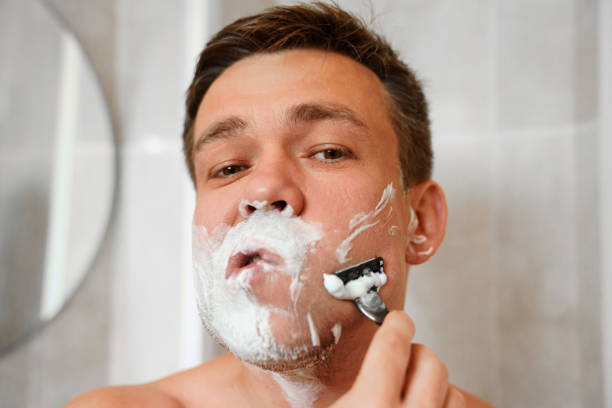 istock A man shaves his face with a safety razor. 1495023112