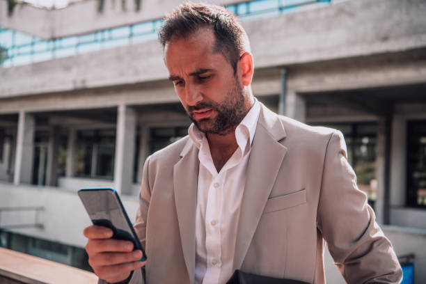 istock A businessman using his smartphone outdoors, showcasing the seamless integration of technology and mobility in modern professional life. 1495024621