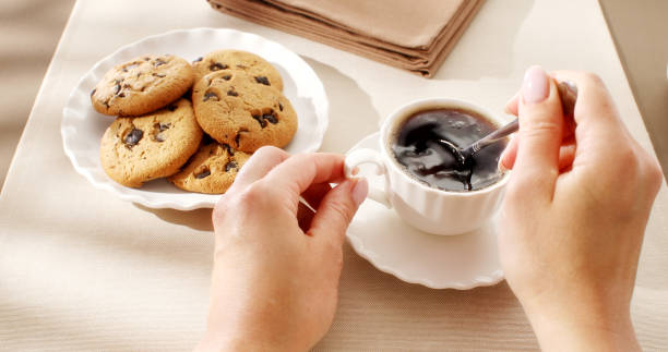 istock Adding sugar to coffee and stiring. First Person view. 1495024808