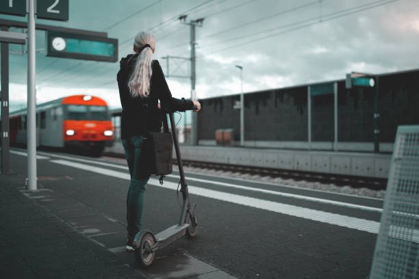 istock Woman with e-scooter waiting for train 1495025917