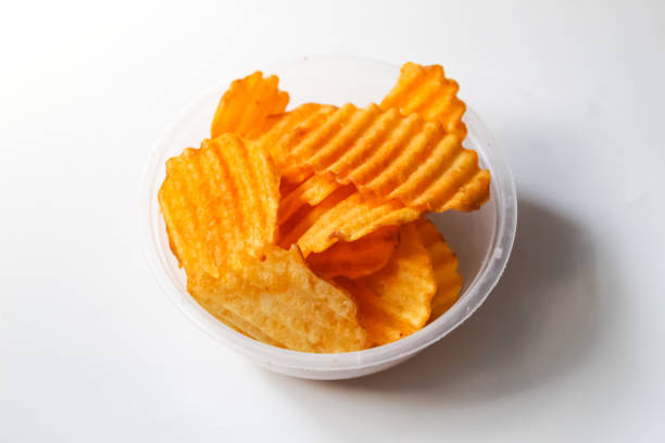 istock Spicy potato chip snack in a bowl, isolated on white background 1495026595