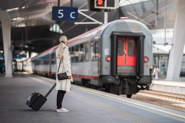 istock woman and train at railway station 1495029150