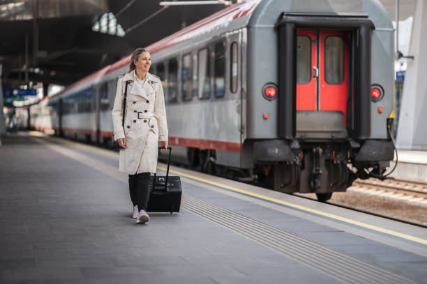 istock woman on train journey walking at railroad station platform 1495029157