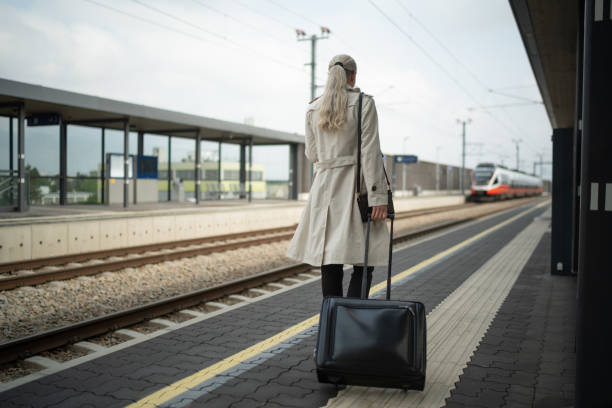 istock Rear view woman walking on rail platform outside 1495029196