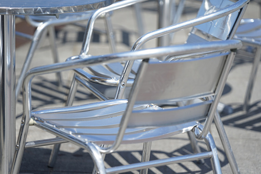 Metal chair in café on sunny day