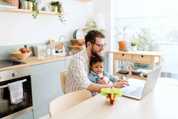 istock Father sending something on a laptop while spending time with his son 1495032403