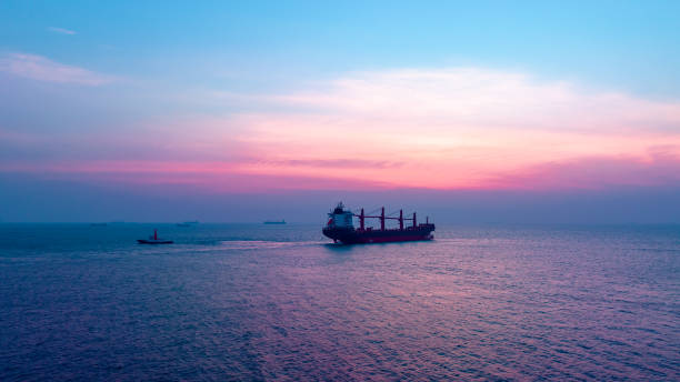 istock Seascape and silhouette container ship floating in sea and over the sunlight background 1495042903