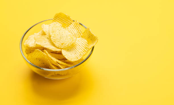 istock Bowl of chips on a yellow 1495043103