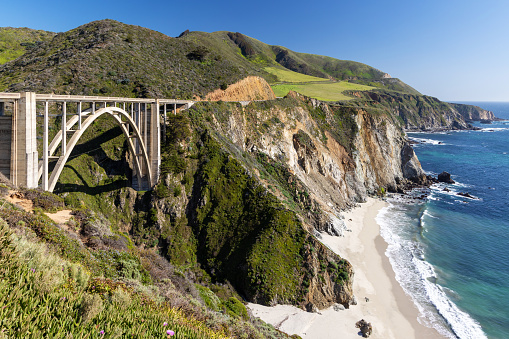 A stunning view of a Bixby Bridge on the ocean coast at Big Sur, California, offering a scenic backdrop for a road trip adventure