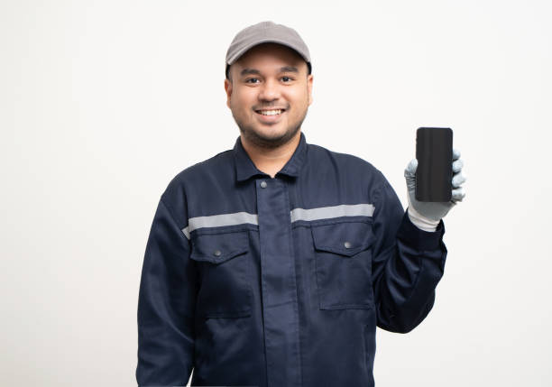 istock Technician workers in uniform maintenance service with smartphone. Profession of service industry house repair. Home services with cellphone isolated background. 1495043488