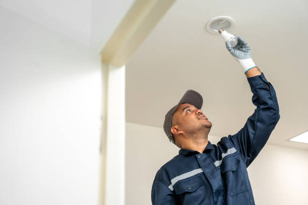istock Electrician installing led light bulbs at home for power saving. Fixing changing the Light Inside apartment. Home service concept. 1495043518