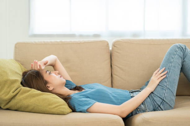 istock Depressed and Stressed asian woman on sofa. Crying sadness female alone in home problem in life. Unhappy asian woman headache Upset frustrated by problem love relationship feeling despair and anxiety 1495043780