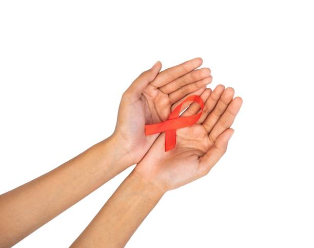 istock Hands holding red ribbon awareness symbol isolated 1495043867