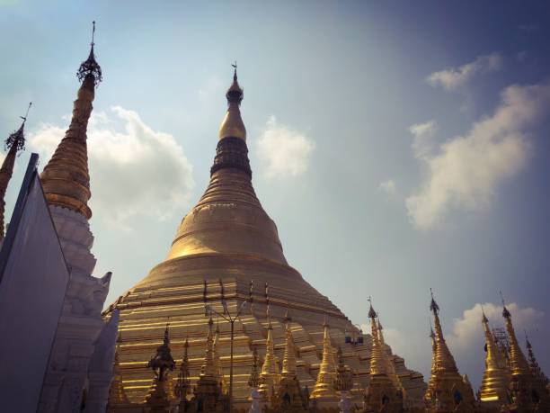 Yangon / Rangoon, Myanmar / Burma: The Sule pagoda or paya, known in Burmese as the Kyaik Athok Zedi, is a temple located in a downtown roundabout. The pagoda is known for the octagonal shape of the base, which is carried over to the golden dome. During the British period, the city center was completely restructured and the pagoda served as the center. Since then, Sule Paya has served as a reference for kilometer distances to the north of the country. The temple has four entrances, oriented towards the four cardinal points. According to tradition, some Buddha 's hair is preserved inside.