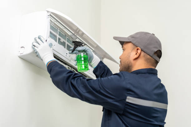 istock Air conditioner service. Air conditioner cleaning technician He opened the front cover and took out the filters and washed it. Holding spray cleaning 1495047134
