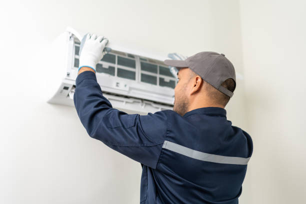 istock Air conditioner service indoors. Air conditioner cleaning technician He opened the front cover and took out the filters and washed it. He in uniform wearing rubber 1495048997