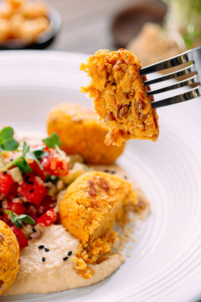 istock Eating vegetarian falafels with hummus 1495051099