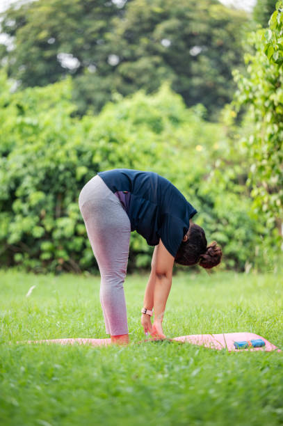 istock Young Woman Doing Yoga Meditation and Stretching Exercises 1495053698