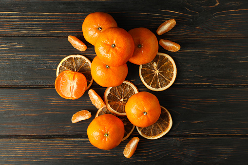 Group of tasty mandarins on rustic wooden background