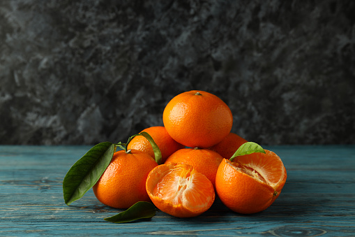 Tasty fresh mandarins on rustic wooden table