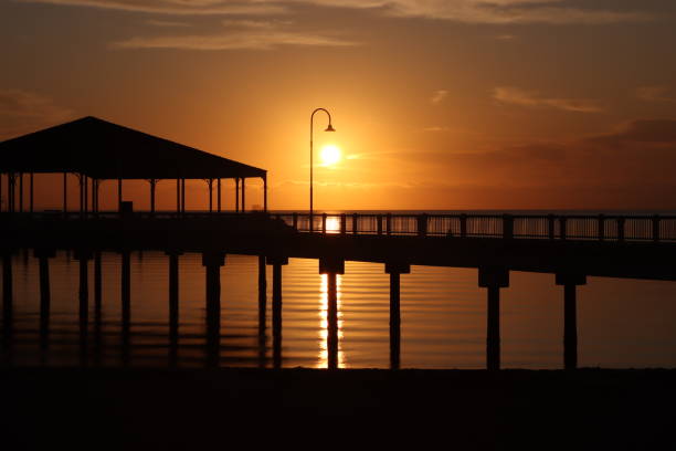 istock Sunrise silhouette of jetty 1495057204