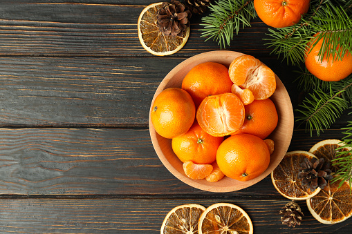 Christmas concept with mandarins on rustic wooden table
