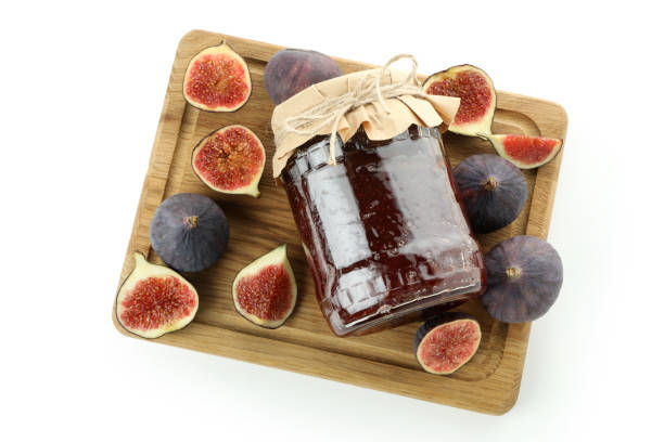 istock Board with fig jam and ingredients isolated on white background 1495059154