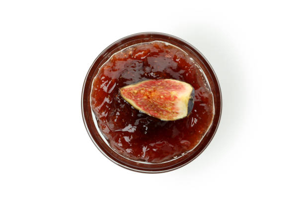 Bowl with fig jam and slice isolated on white background