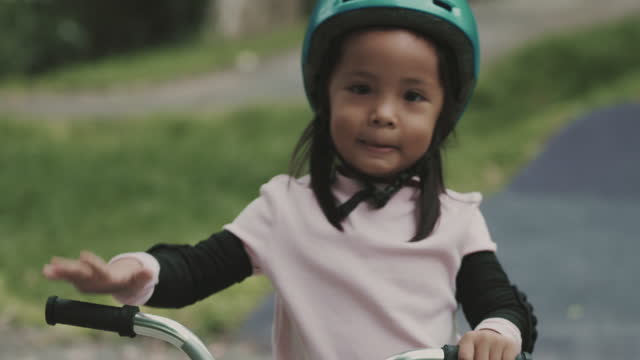 Little girl practicing balance bike