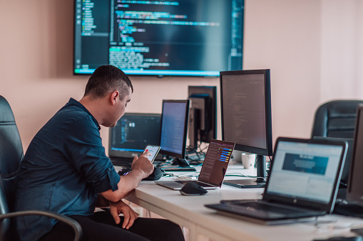 A Programmer Diligently Testing Smartphone Applications While Sitting ...