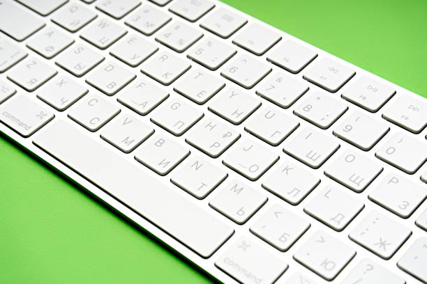 istock Woman Typing On A Keyboard White wireless computer keyboard isolated on white background. Russian / English keyboard layout. 1495075802