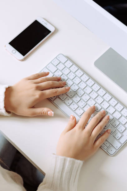 istock Unrecognizable businesswoman sitting at desk, using laptop 1495076261