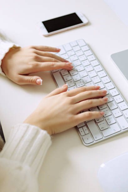 istock Unrecognizable businesswoman sitting at desk, using laptop 1495076284