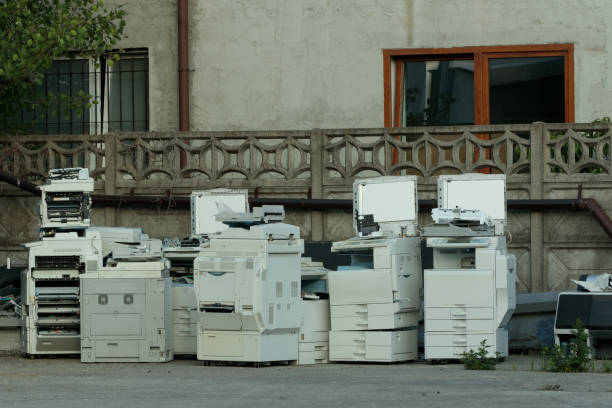 Problem with e-waste: heap of old printers, equipment