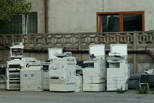 Problem with e-waste: heap of old printers, equipment