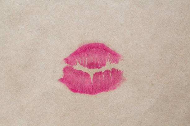 Abstract pink kisses isolated on white background. Lots of female lip prints on paper. Beautiful neon lips stamps. Valentine's day, romantic mood and love concept.