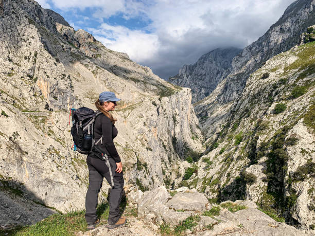 istock Woman hiker climbing a mountain 1495079833