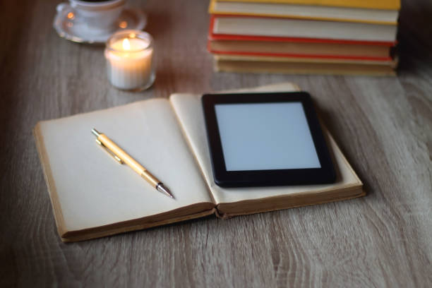 istock Books, Glasses, E-Reader, Pen, Tea, Cookies and Candles 1495079909