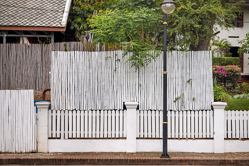 Luang Prabang, Laos - March 13th 2023: Different kind of fences in front of a residential building in the center of the former capital of Laos