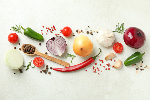 Different spicy vegetables on white textured background