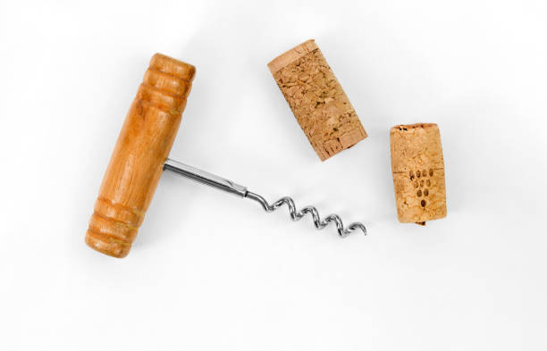 istock Bottle opener. Corkscrew with wooden handle and wine cork stopper isolated on white background with copy space. 1495084740
