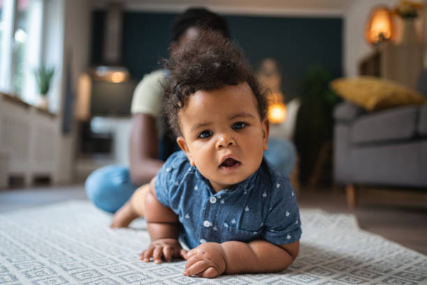 istock Mixed-race baby boy crawling on the carpet 1495086472