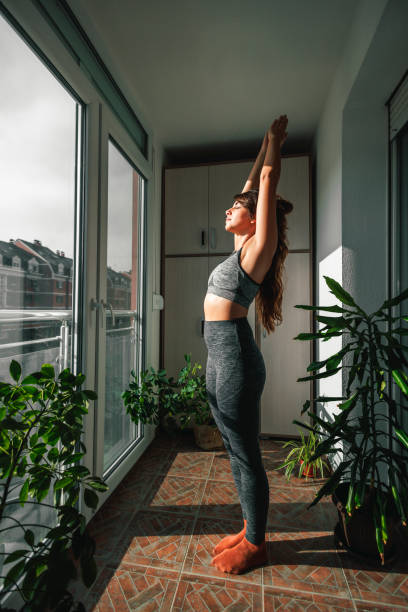istock Woman doing yoga holding warrior one pose 1495086600