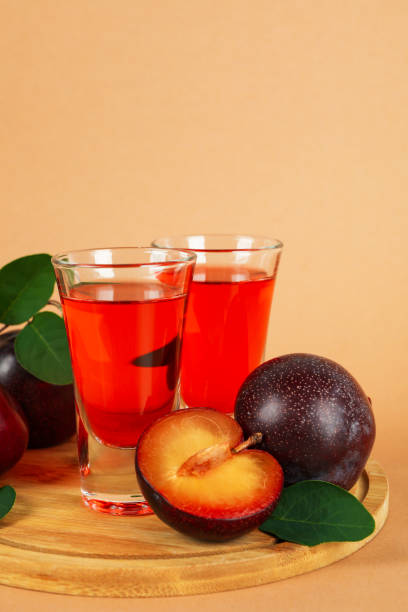 istock Plum brandy shots and ingredients on beige background 1495086610