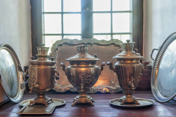 istock Three old samovars and silver trays on wooden windowsill 1495087774
