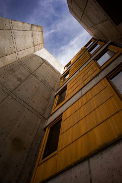 istock Large concrete building with a vividly colored yellow facade and side windows 1495087782