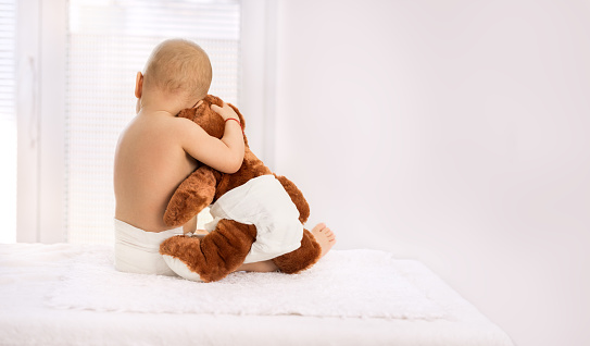 My best friend, little baby hugging soft bear toy