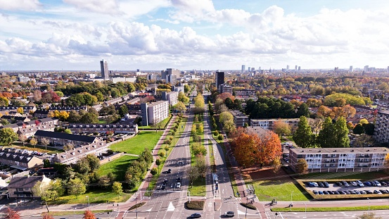 View of vibrant urban Eindhoven cityscape, featuring multiple buildings and trees