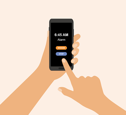 Smartphone With Alarm Clock App, Snooze And Stop Buttons On Screen. Hand Holding Smartphone